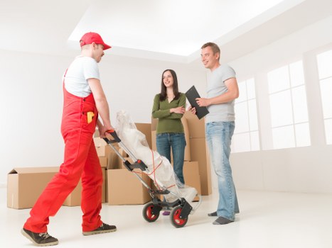 Removalists handling furniture in a Mayfair apartment building